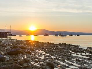 Morning atmosphere at Lake Garda. The water level is historically low, so rocks and stones on the...