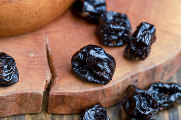 Black pile of prunes from a large number of ripe plums