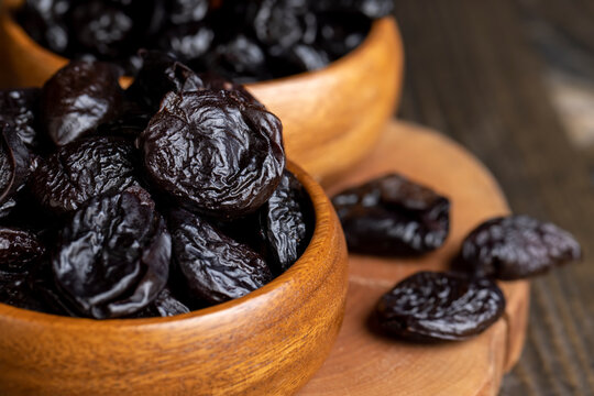 Black pile of prunes from a large number of ripe plums
