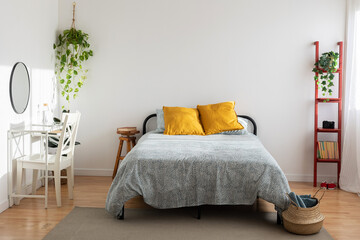 Bright minimal cozy interior bedroom with bed and desk. Home interior room concept