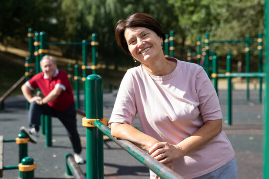 Portrait of an mature woman in sportswear on a sports ground in city park