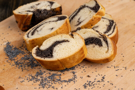 A large number of poppy seeds in a wheat bun