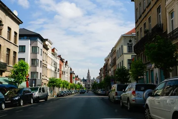 Rolgordijnen Brussels residential area city streets with cars parked on both sides of the street © Kaspars