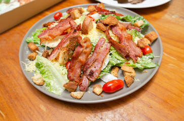 Salad with bacon and cheese and Caesar dressing