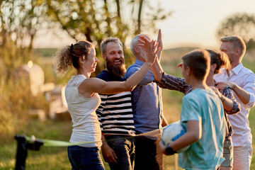 Family high-fiving after playing volleyball