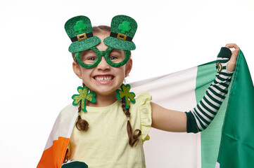 Adorable little girl wearing stylish carnival eyewear and clover leaves earrings, for Saint...