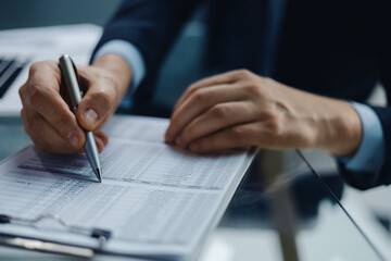 Image of businessman hands taking business notes at office.