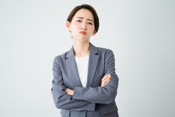 腕を組んで怒っている若い女性　ビジネスイメージ