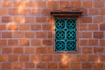 Chinese style window over the red brick wall building