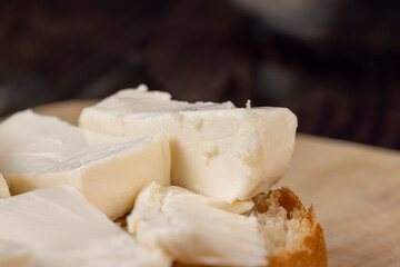 Wheat bun with large pieces of processed cheese inside
