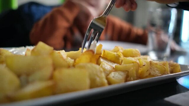 typical spanish tapas seafood fish potatoes tortilla hands children family eating spain vacation healthy food mediterranean