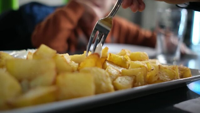 typical spanish tapas seafood fish potatoes tortilla hands children family eating spain vacation healthy food mediterranean