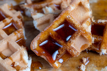 Soft fresh waffles with bee honey close-up