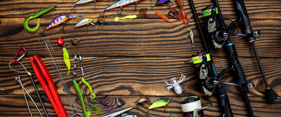 Fishing tackle on a wooden background. Fisherman Gear for catching Fish. Panoramic banner. - 580344778