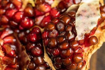 Rotten spoiled red ripe pomegranate on the board