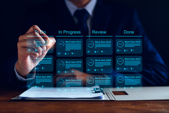 Agile software development or project management using kanban or scrum methodology boards on screen. Process, workflow, visual organisation tools and framework. Developer touching virtual interface.