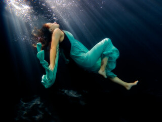 Reagan Swenson underwater with dress floating
