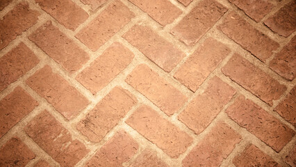Top view of Reddish-brown brick sidewalk, old, worn, pavement with zigzag patterns. Concept for construction, urban environment improvement, finishing works, landscape design.