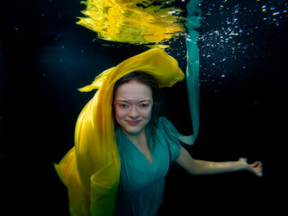 Reagan Swenson underwater with dress floating