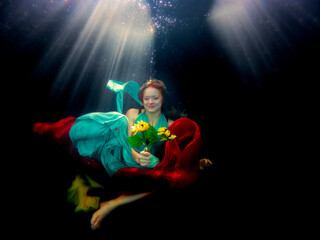 Fototapeta na wymiar Reagan Swenson underwater with dress floating