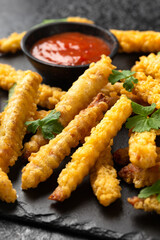 Fried Vegan jackfruit and oyster prawns in crispy batter served on black slate with chili dip sauce