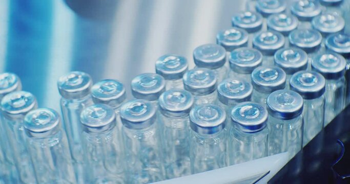 pharmaceutical industry.modern industrial equipment.a lot of glass vials are moving along the production line.close-up.