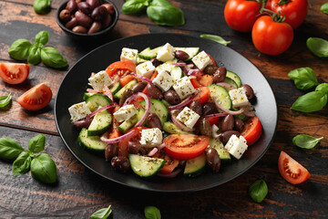 Greek salad with fresh vegetables, feta cheese, kalamata olives, dried oregano, red wine vinegar...