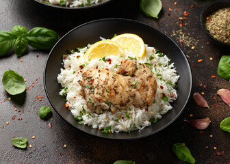 Grilled Chicken thighs served with rice in a black bowl