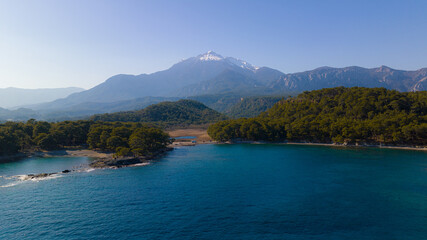mountain landscape. Mountain lake and sea view. Mountain among the trees and snow on the mountain peak