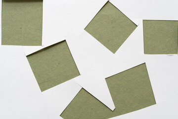 paper squares and rough green paper