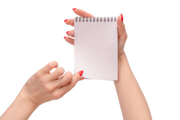 A notebook with empty white paper in woman hands with red nails.