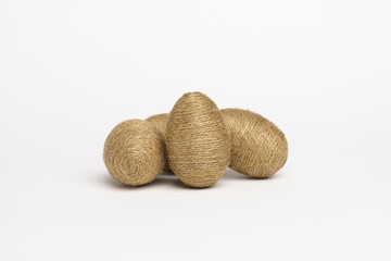 Hand wrapped easter eggs with jute twine, isolated white background.