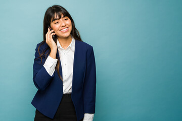 Happy business woman making a call on the smartphone