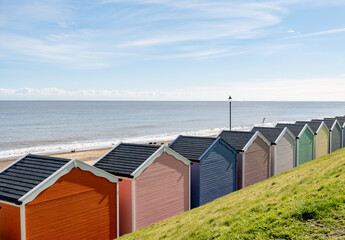 Colourful beach huts on the promenade or esplanade in the seaside town of Gorleston on the Norfolk coast - obrazy, fototapety, plakaty