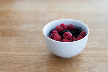 Raspberries and blackberries in a bowl