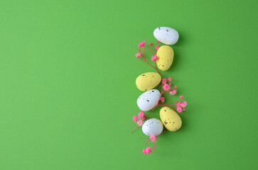 Easter eggs with pink flowers on a green background. Easter.