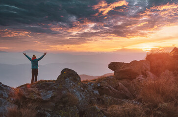 Lone tourist meets mountain sunset