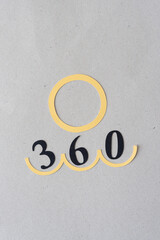 paper circle and the number 360 on gray cardboard