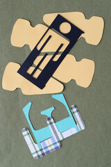collection of cut paper shapes and the letter e on neutral green paper