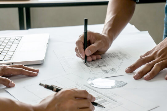 Architecture drawing on architectural project business architecture building construction Colleagues interior designer Corporate Planning Design on blueprint Teamwork with compasses.