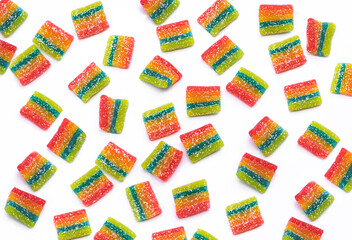 Rainbow juicy gummy candies background. Top view. Pattern from jelly sweets on white background
