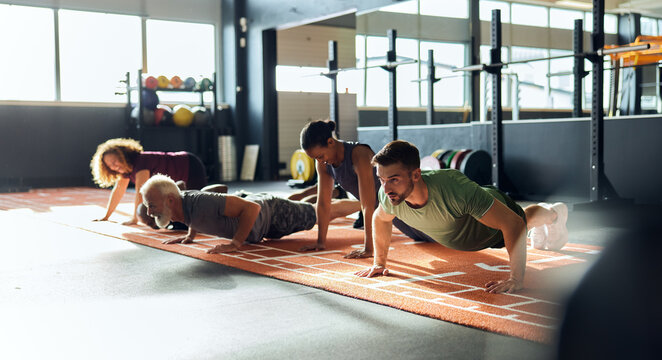 People doing push-ups in a gym