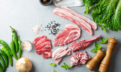 Various cuts of meat, spices and vegetables