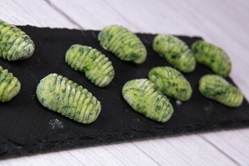 Pile of green spinach gnocchi, potato peru italian food, Homemade, High quality photo