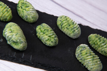 Pile of green spinach gnocchi, potato peru italian food, Homemade, High quality photo