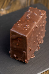 Fresh sweet cake with milk taste and aroma in chocolate glaze