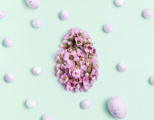 Easter egg in the form of colorful spring flowers. The concept of minimal rest. Flat lay pattern.