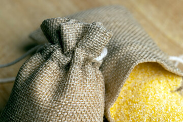 Linen bag of small size with dry corn flour for cooking porridge