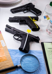 various sealed automatic pistols in crime lab, crime investigation, concept image