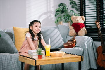 Little girl kid watching tv and movie on sofa in living room leisure activity on vacation.